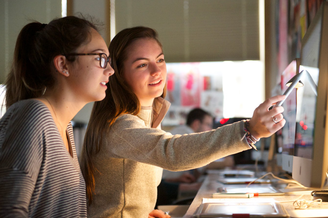 Two boarding school students working together at a computer